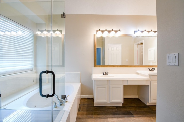 241 Blue Hill Dr, Montgomery, TX 77356 - bathroom with a tub with jets, double vanity, a sink, and wood finished floors