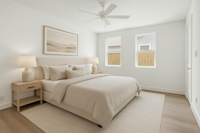 bedroom featuring baseboards, ceiling fan, and light wood finished floors