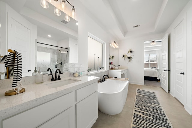 full bath featuring visible vents, a freestanding tub, walk in shower, tile patterned floors, and a raised ceiling