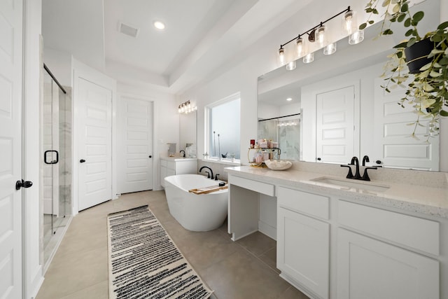 full bath featuring vanity, a freestanding tub, tile patterned flooring, and a stall shower