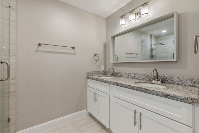 1015 Gardendale Dr, Houston, TX 77018 - bathroom featuring baseboards, a sink, a stall shower, and double vanity