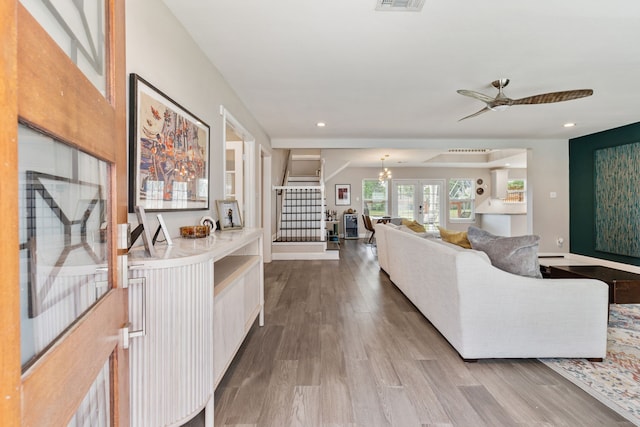 1015 Gardendale Dr, Houston, TX 77018 - living area featuring visible vents, stairs, wood finished floors, ceiling fan with notable chandelier, and recessed lighting