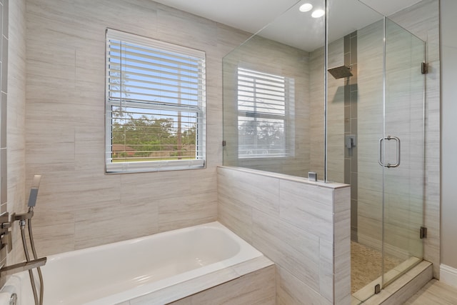 1015 Gardendale Dr, Houston, TX 77018 - full bathroom featuring a garden tub, plenty of natural light, and a stall shower