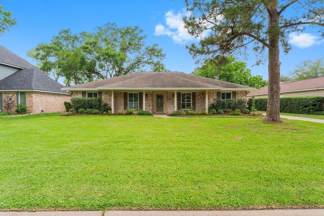 single story home featuring brick siding and a front lawn