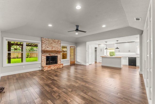 unfurnished living room with a ceiling fan, baseboards, visible vents, and a fireplace