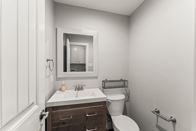 half bath with vanity and toilet