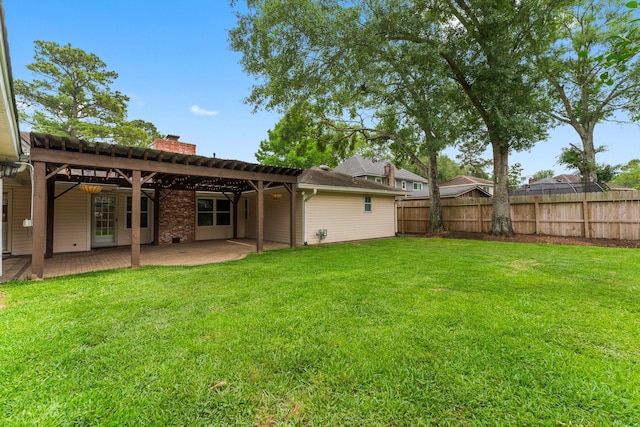 rear view of house featuring a lawn, a patio, fence, and a chimney