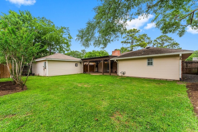 rear view of house with a chimney, a lawn, a patio area, a fenced backyard, and a pergola