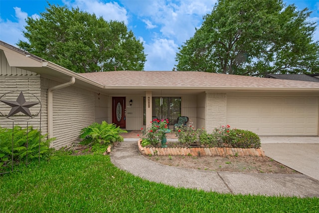 property entrance featuring an attached garage, roof with shingles, covered porch, and concrete driveway