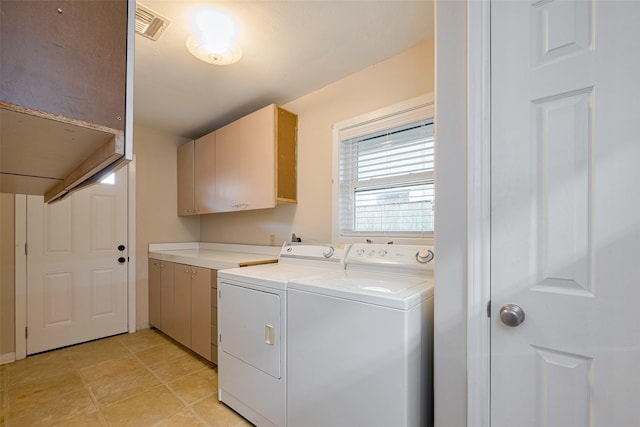 laundry room with cabinet space, visible vents, and washer and clothes dryer