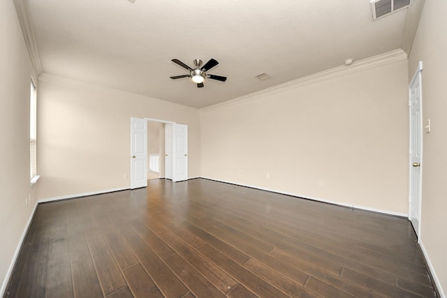 unfurnished room featuring crown molding, a ceiling fan, dark wood finished floors, and visible vents