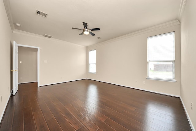 spare room with visible vents, a ceiling fan, dark wood finished floors, and crown molding