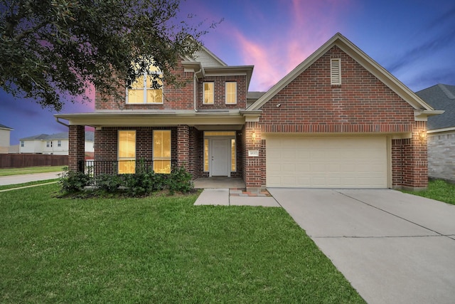 traditional-style home with a porch, driveway, brick siding, a yard, and an attached garage