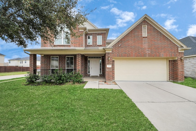 traditional home with brick siding, a garage, a front yard, covered porch, and driveway