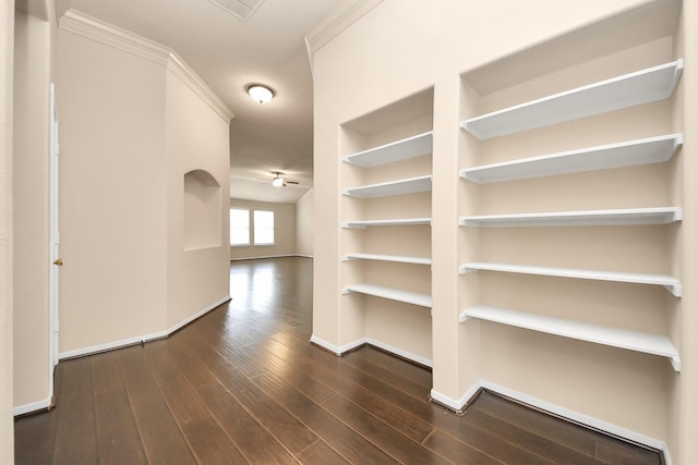 hallway featuring baseboards, dark wood-style flooring, and visible vents