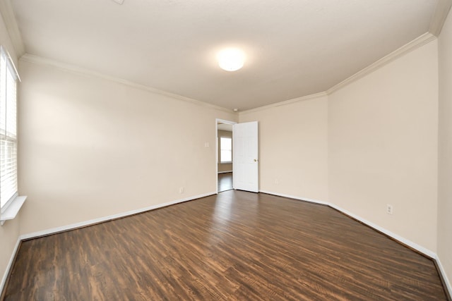 empty room with baseboards, ornamental molding, and dark wood-style flooring