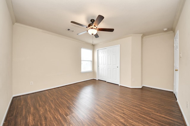 unfurnished bedroom with dark wood-style flooring, baseboards, visible vents, and ornamental molding