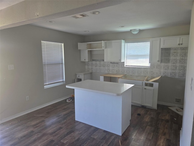 6403 O Brien St, Hitchcock, TX 77563 - kitchen with decorative backsplash, dark wood-type flooring, a kitchen island, white cabinets, and recessed lighting