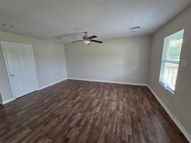 6403 O Brien St, Hitchcock, TX 77563 - spare room featuring dark wood-type flooring, a ceiling fan, and baseboards