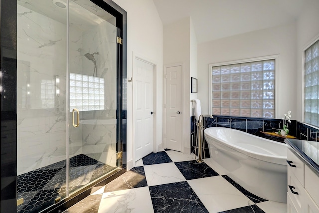 full bathroom featuring vanity, marble finish floor, a freestanding tub, and a marble finish shower
