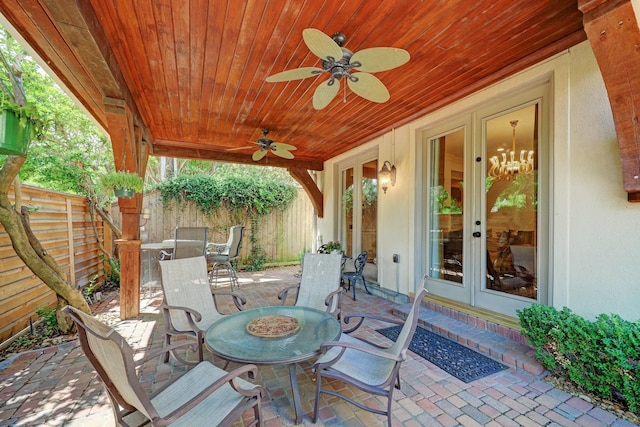 view of patio featuring a fenced backyard, a ceiling fan, outdoor dining area, and french doors