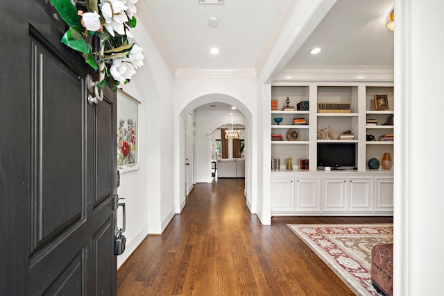foyer with crown molding, baseboards, dark wood-style floors, recessed lighting, and arched walkways