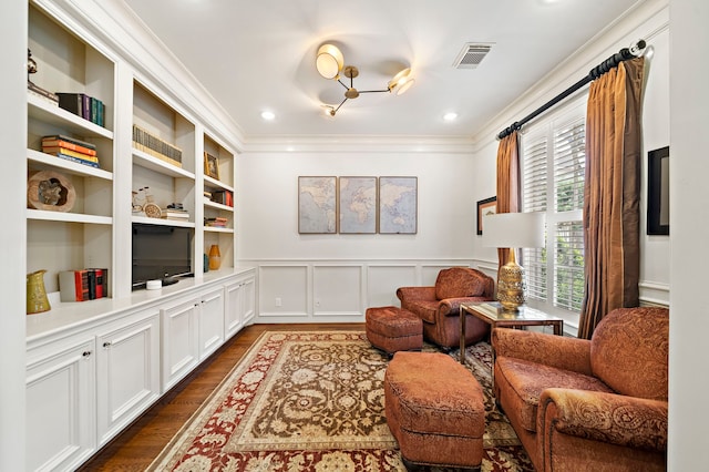 living area featuring ornamental molding, wainscoting, dark wood-style flooring, and visible vents