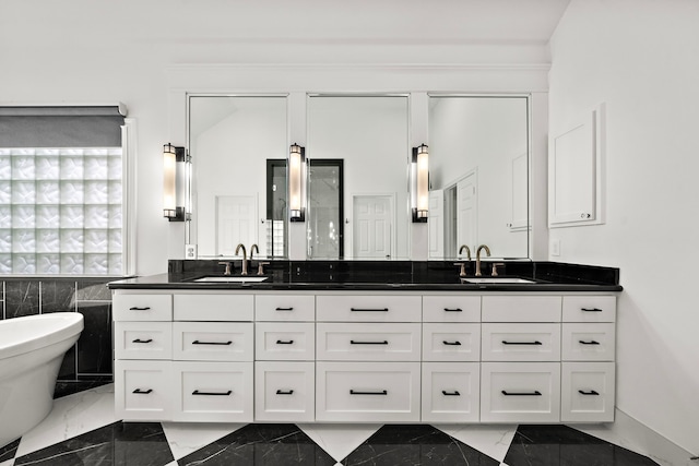 bathroom featuring double vanity, a sink, and marble finish floor