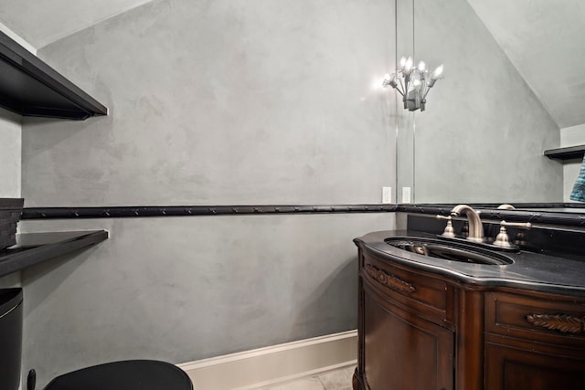 half bathroom with marble finish floor and vanity