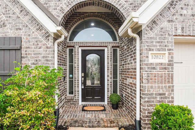 property entrance featuring brick siding and stone siding