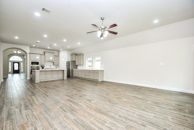 unfurnished living room featuring a healthy amount of sunlight, recessed lighting, ceiling fan, and light wood finished floors