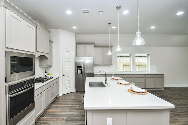 kitchen featuring dark wood-style flooring, appliances with stainless steel finishes, visible vents, and tasteful backsplash