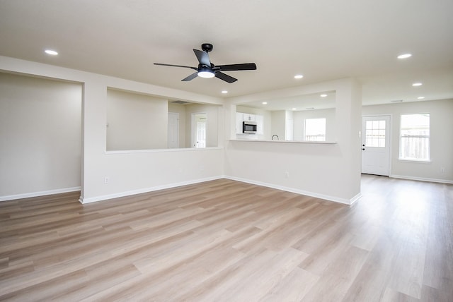 unfurnished living room with recessed lighting, ceiling fan, and light wood-type flooring
