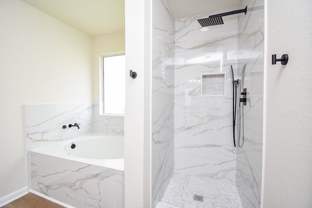 bathroom with a marble finish shower and a bath