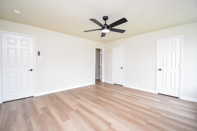 unfurnished bedroom featuring baseboards, ceiling fan, and light wood finished floors