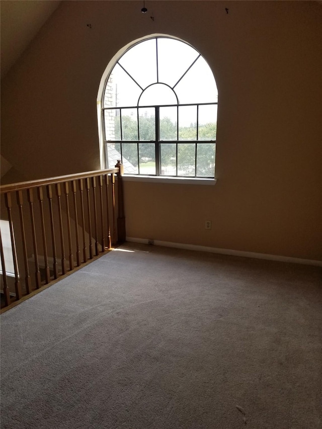 carpeted empty room with baseboards