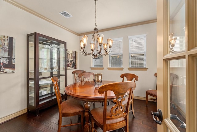dining space featuring visible vents, crown molding, dark wood-type flooring, and a chandelier