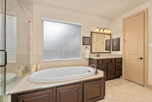 full bath featuring a stall shower, a garden tub, and vanity