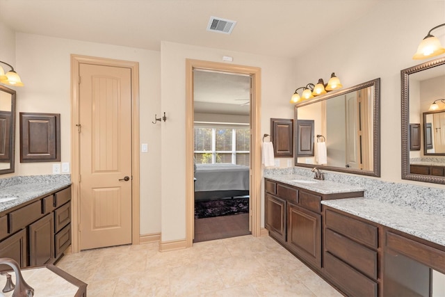 bathroom with visible vents, tile patterned flooring, two vanities, a sink, and ensuite bathroom