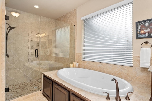bathroom with a tub with jets and a shower stall