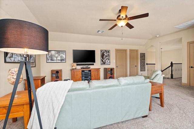 living room with visible vents, ceiling fan, and light colored carpet