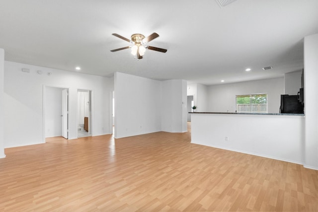unfurnished living room with baseboards, ceiling fan, recessed lighting, and light wood-style flooring