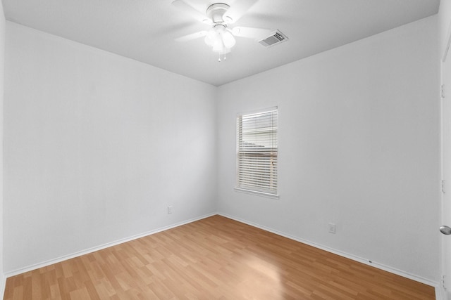unfurnished room with baseboards, light wood finished floors, and ceiling fan