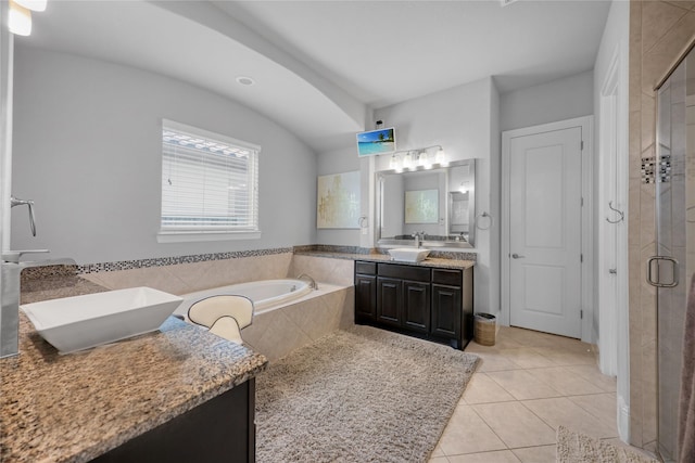 full bath featuring a bath, vanity, tile patterned flooring, and a stall shower