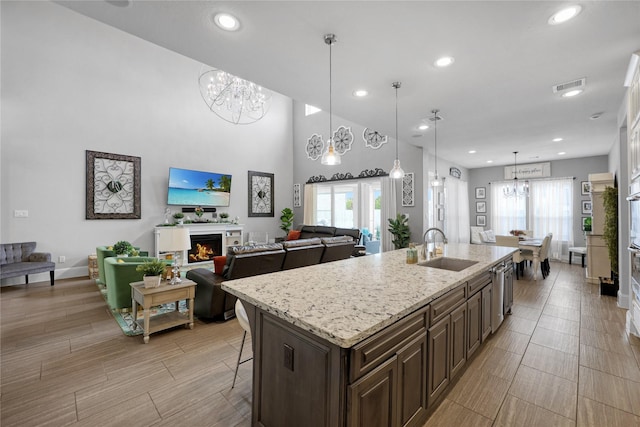 kitchen featuring visible vents, a sink, a notable chandelier, and recessed lighting