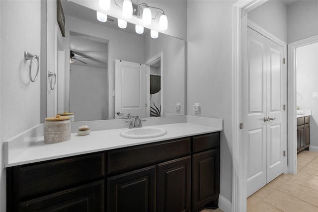 full bathroom featuring tile patterned flooring, a ceiling fan, baseboards, and vanity