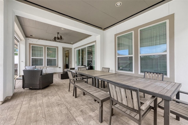 exterior space with outdoor dining area, ceiling fan, and outdoor lounge area