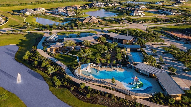 birds eye view of property featuring a water view and a residential view