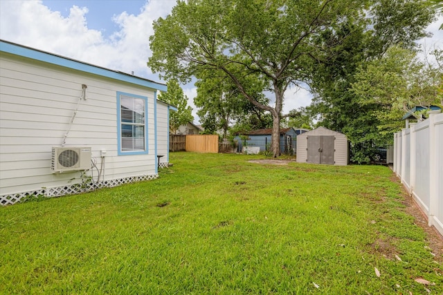 view of yard with an outbuilding, ac unit, a fenced backyard, and a storage unit
