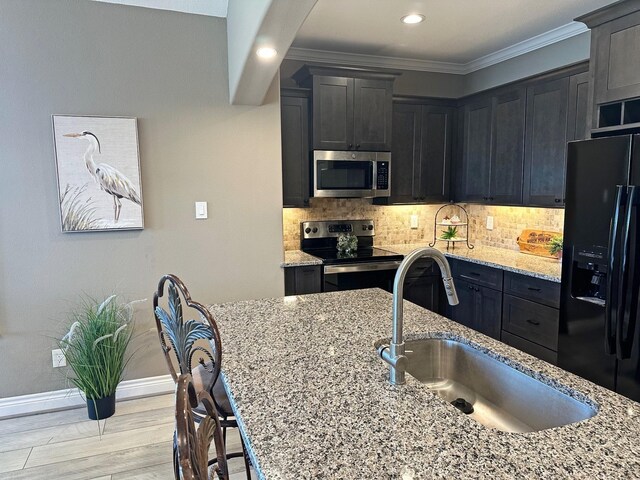 2112 Fm 3186 Unit 9, Onalaska, TX 77360 - kitchen featuring appliances with stainless steel finishes, a sink, light stone countertops, backsplash, and recessed lighting